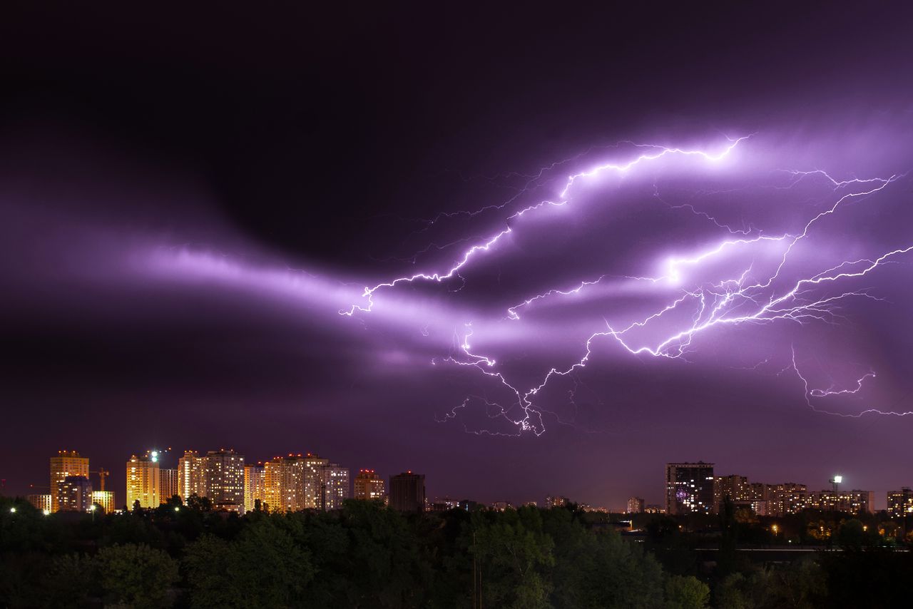 Crafting Captivating Headlines: Your awesome post title goes here An electrifying lightning storm illuminates a modern city skyline at night, showcasing nature's power.